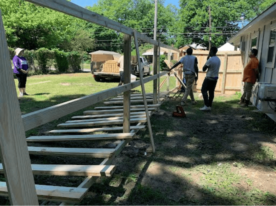 Volunteers gathered to assemble a new fence for Mr. Henry Comas and his two service dogs, Kaki and Whopper, at his new Homes for Hearts tiny house on Saturday, May 17. - Mr. Zachary Waters